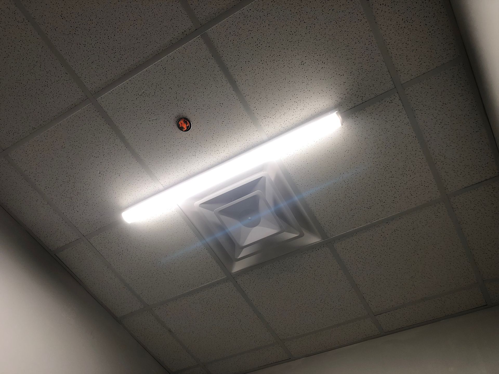 a light is shining from the ceiling of a room