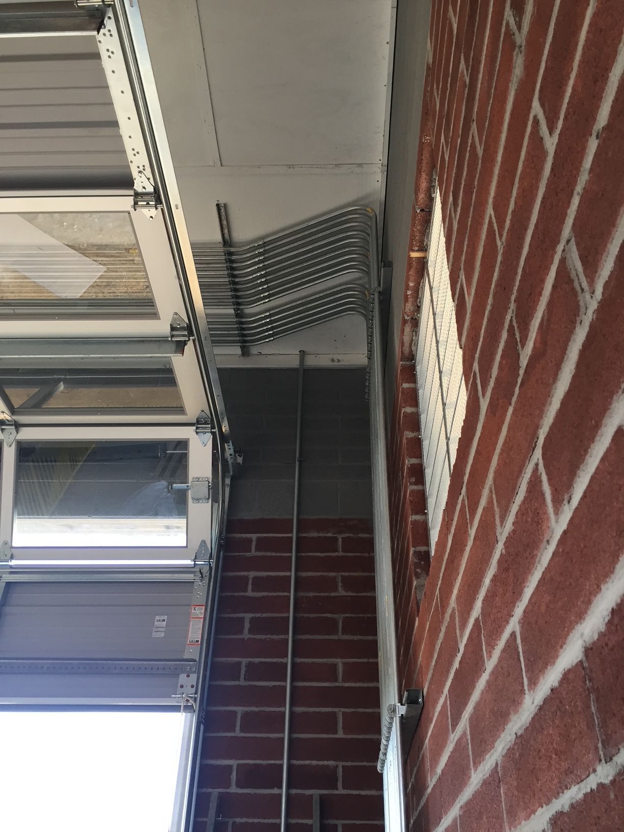 a brick wall with a metal pipe coming out of it 