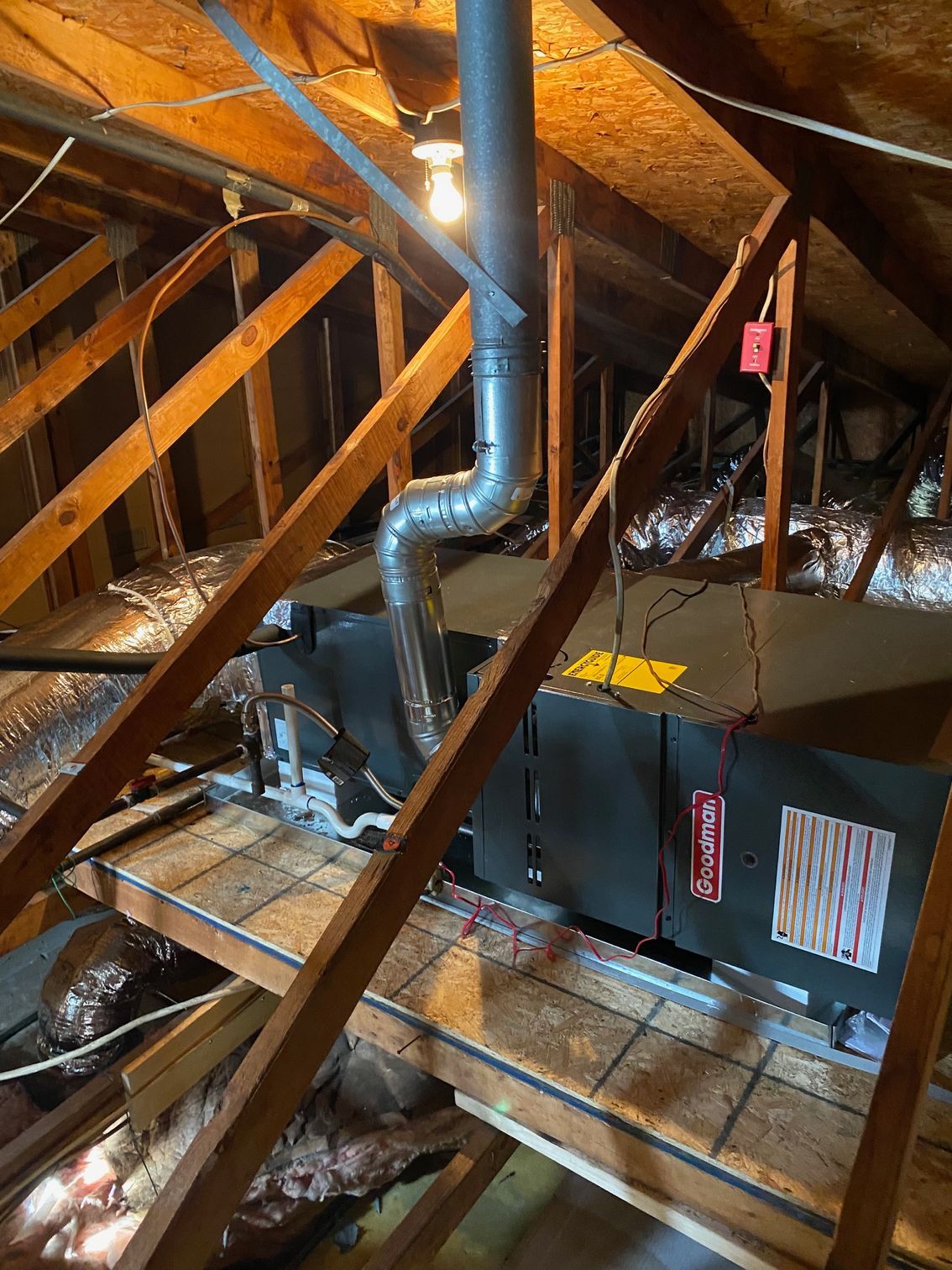an air conditioner is installed in the attic of a house