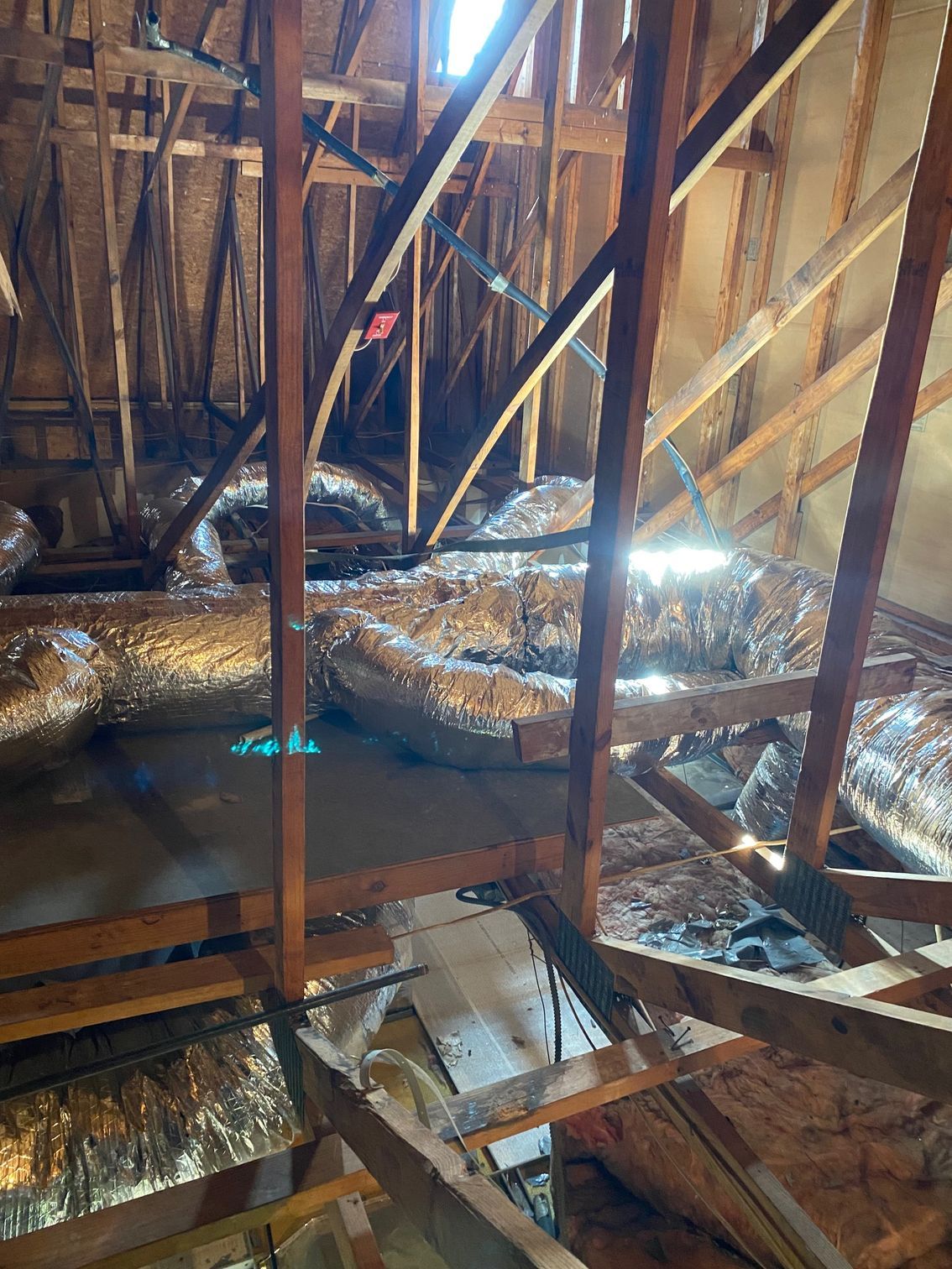 there are a lot of ducts in the attic of a house