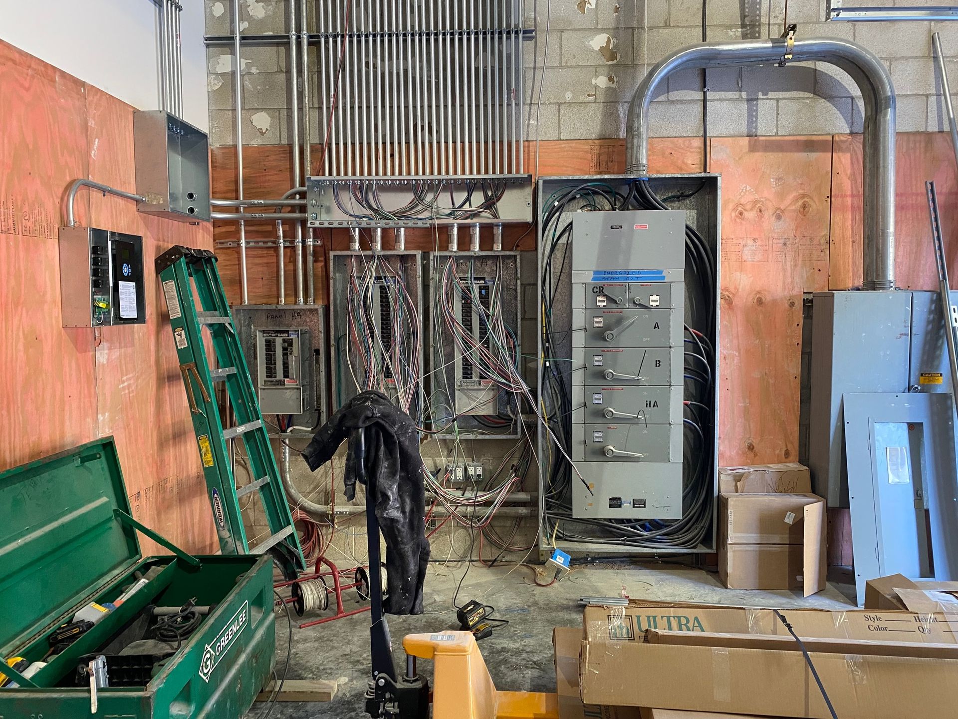 a man is working on a electrical box in a warehouse