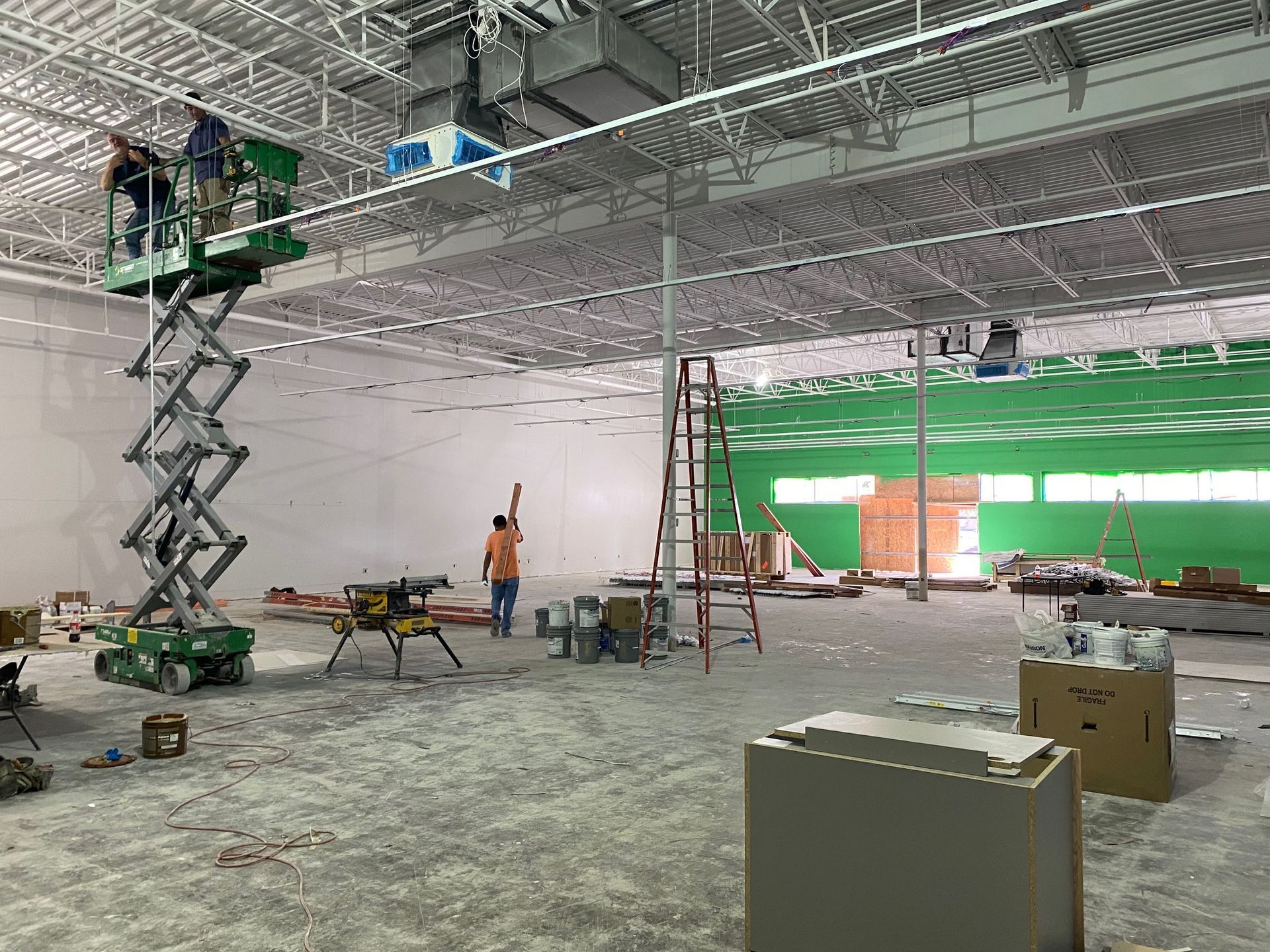 a group of construction workers are working on a large building