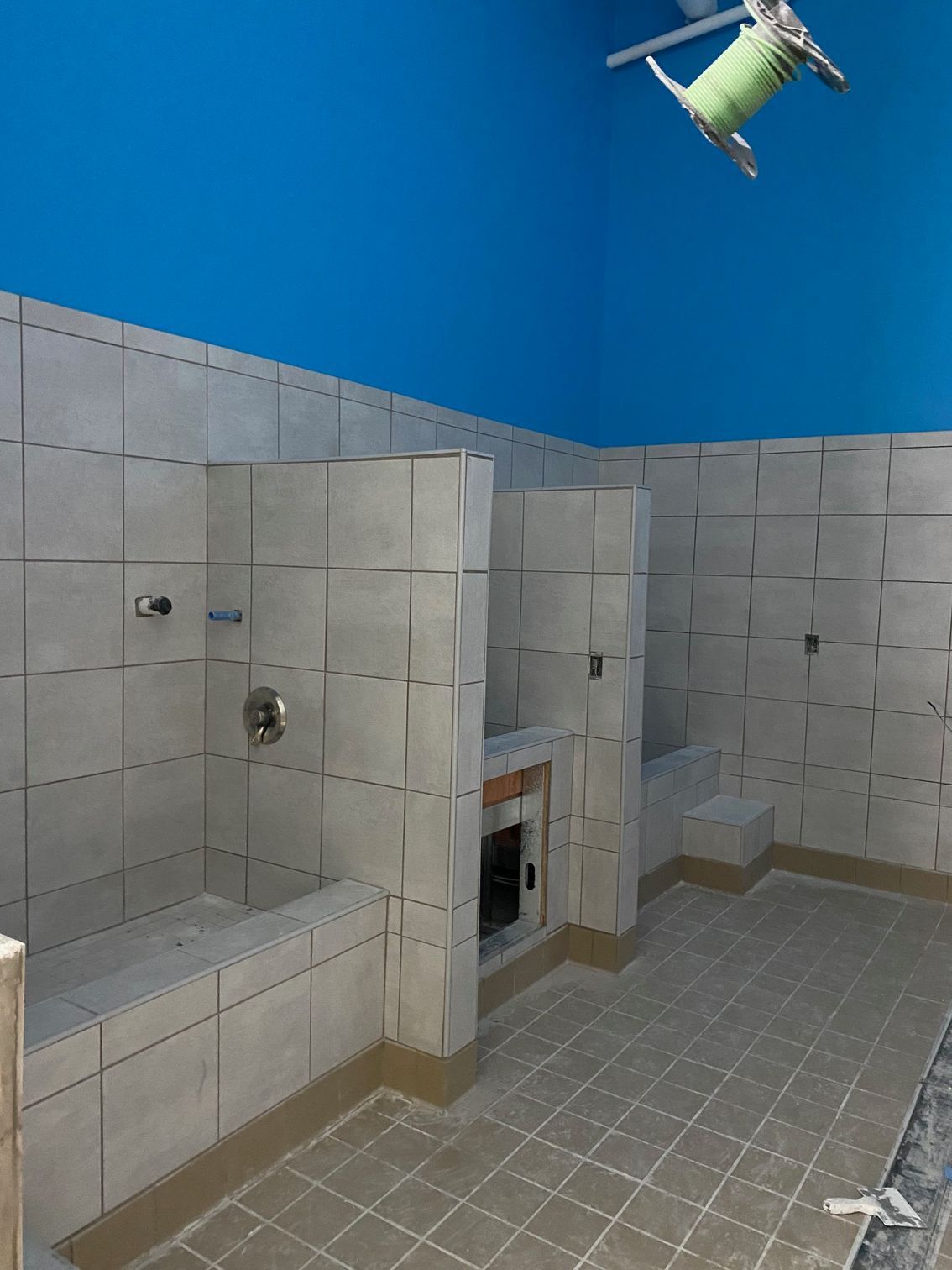 a bathroom with a green chair hanging from the ceiling