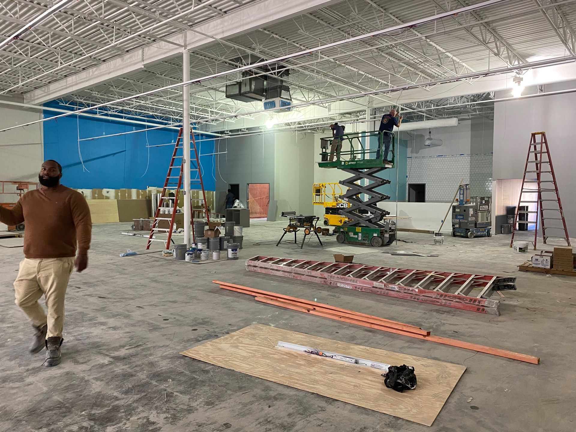 a man is standing in an empty building under construction