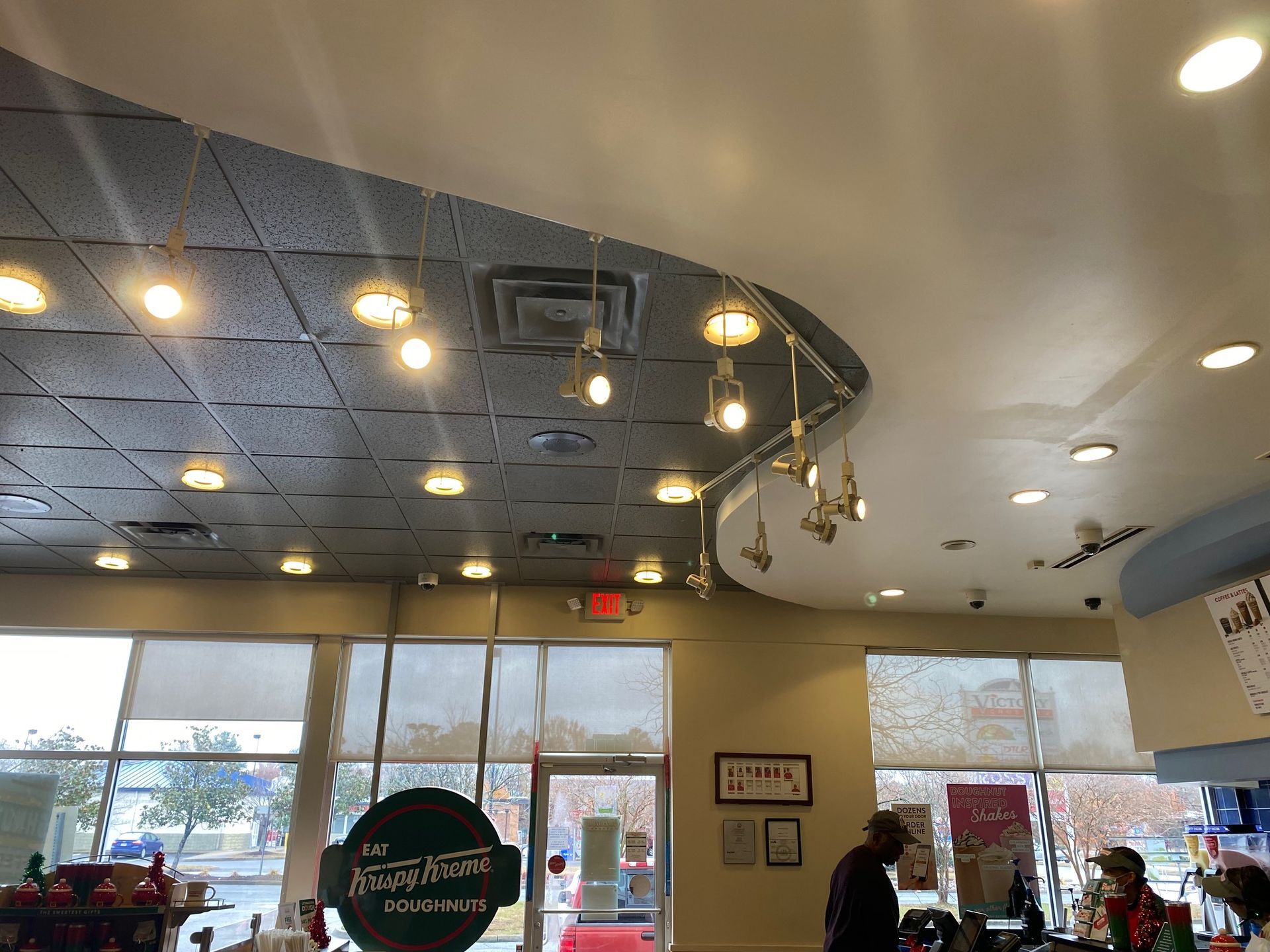 a man is standing in a restaurant looking up at the ceiling