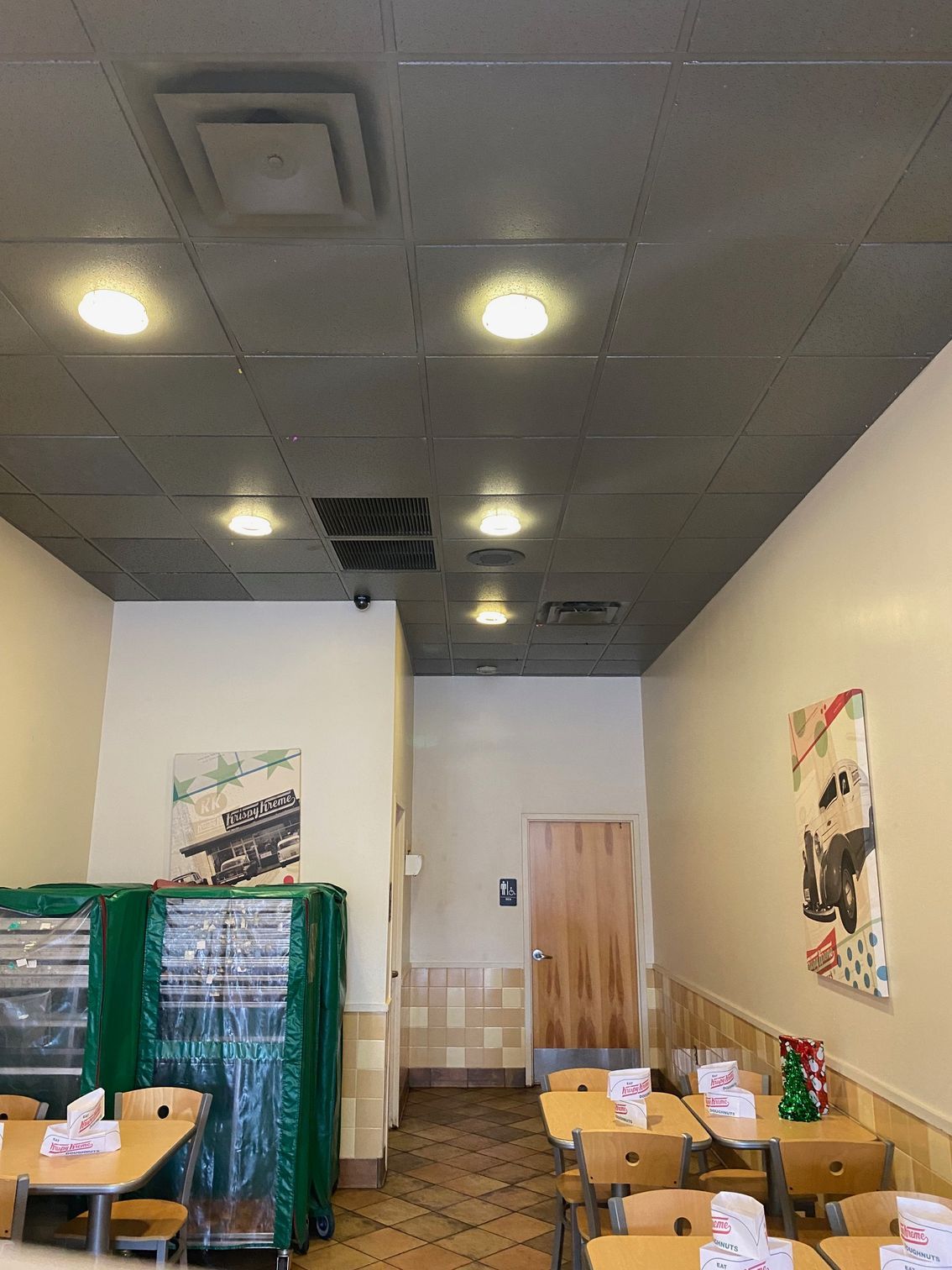 the inside of a restaurant with tables and chairs and a ceiling