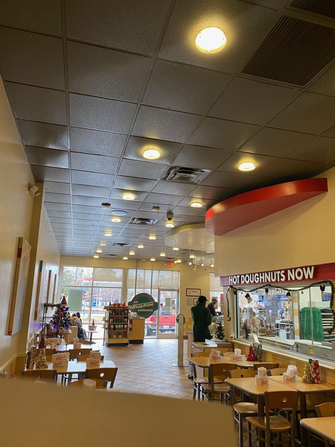 a restaurant with tables and chairs and a sign that says nuts now