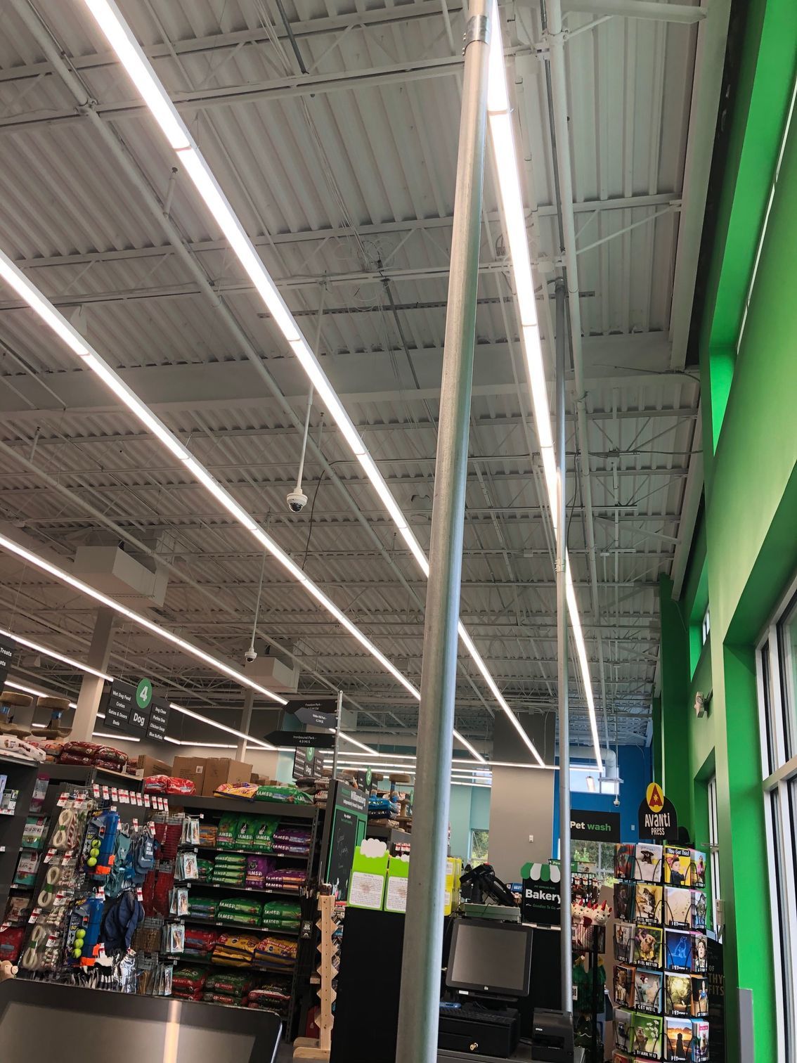 the inside of a grocery store with a lot of lights on the ceiling