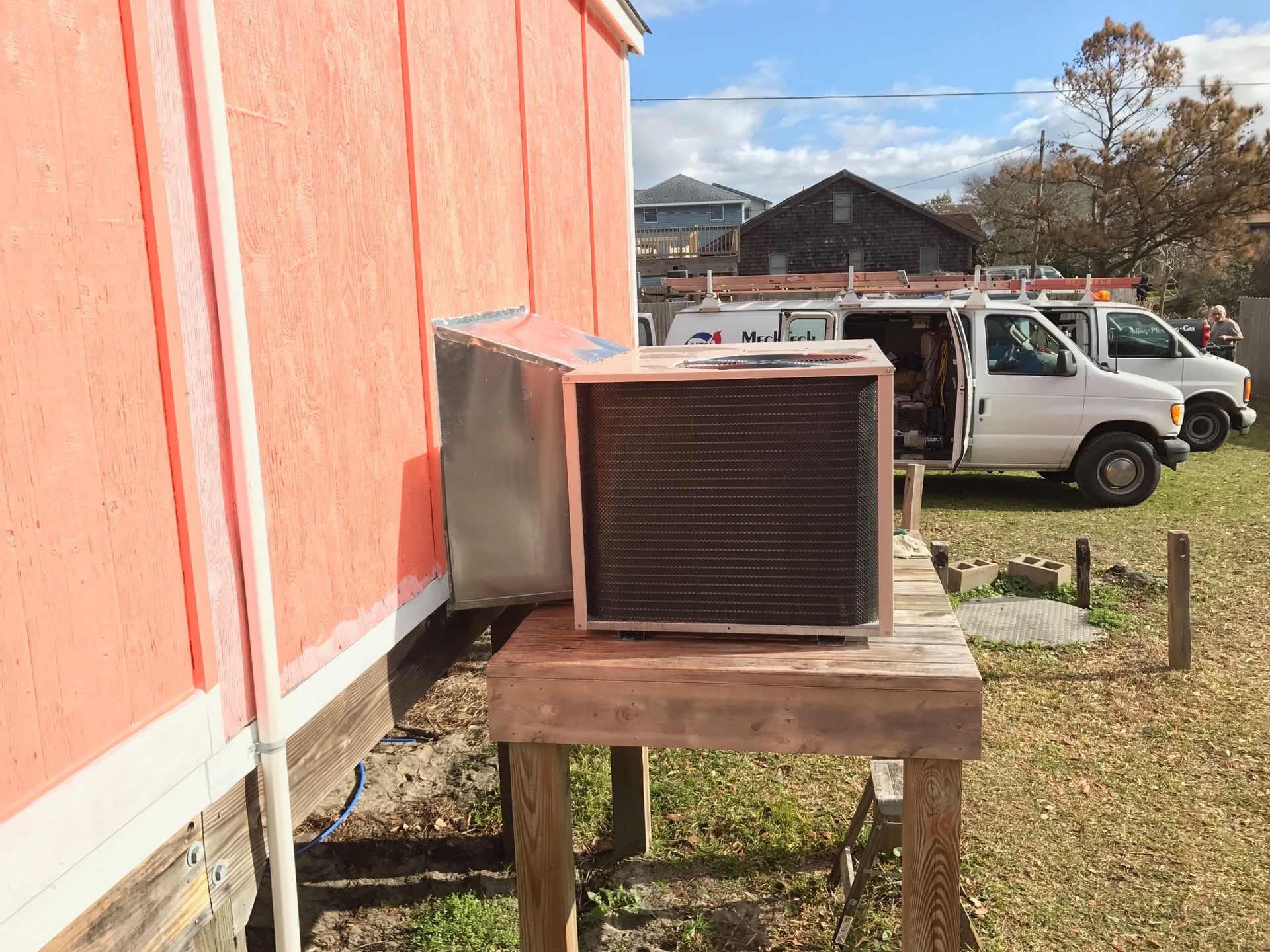a white van is parked in front of a red building 