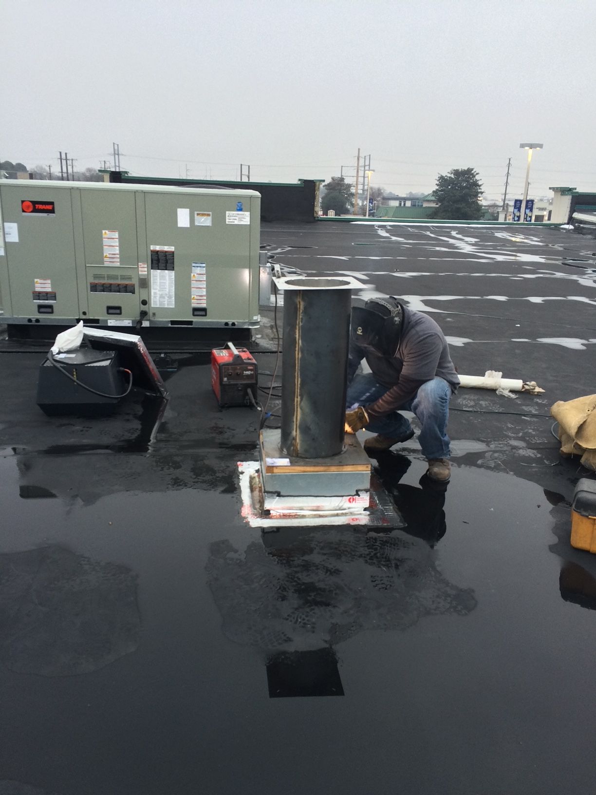 a man is working on the roof of a building