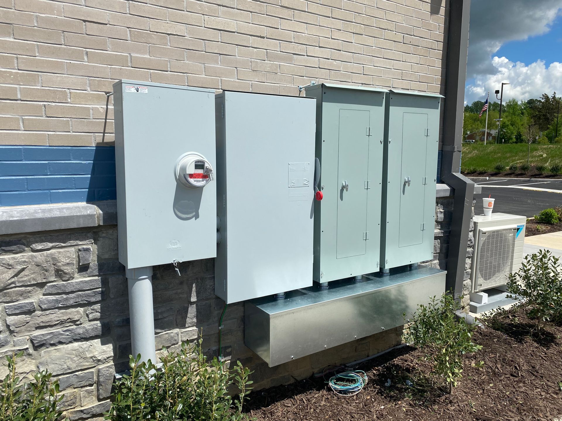 there are a lot of electrical boxes on the side of a building