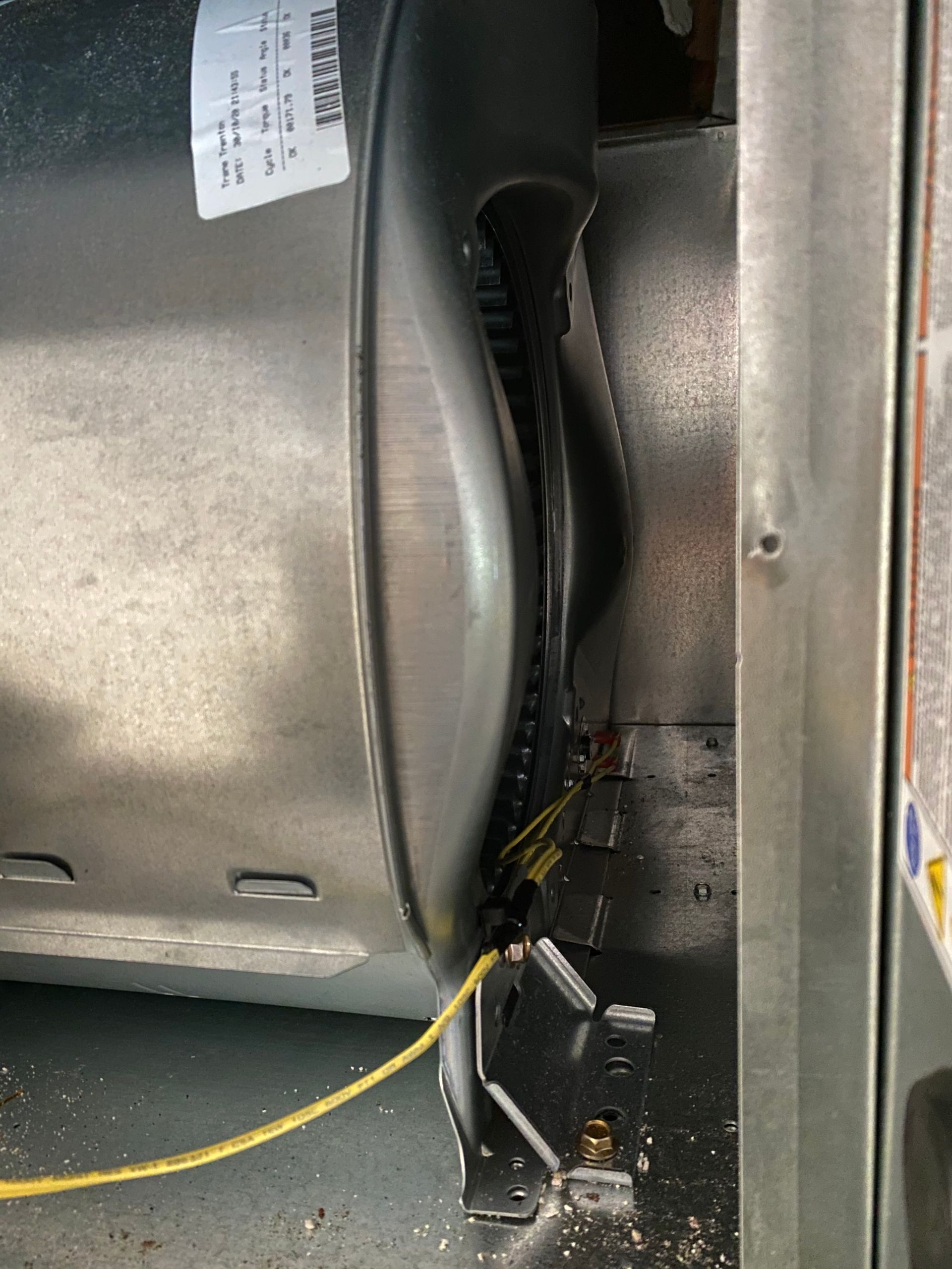 a close up of a fan with a yellow wire attached to it