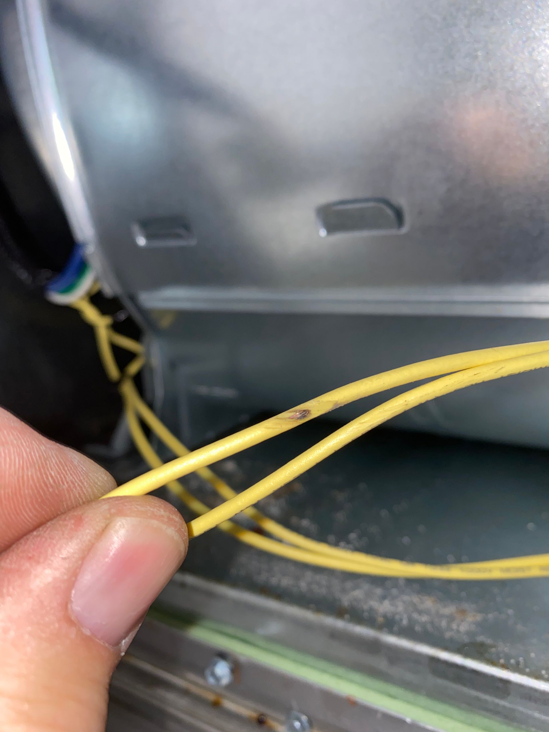 a person is holding a yellow wire in their hand