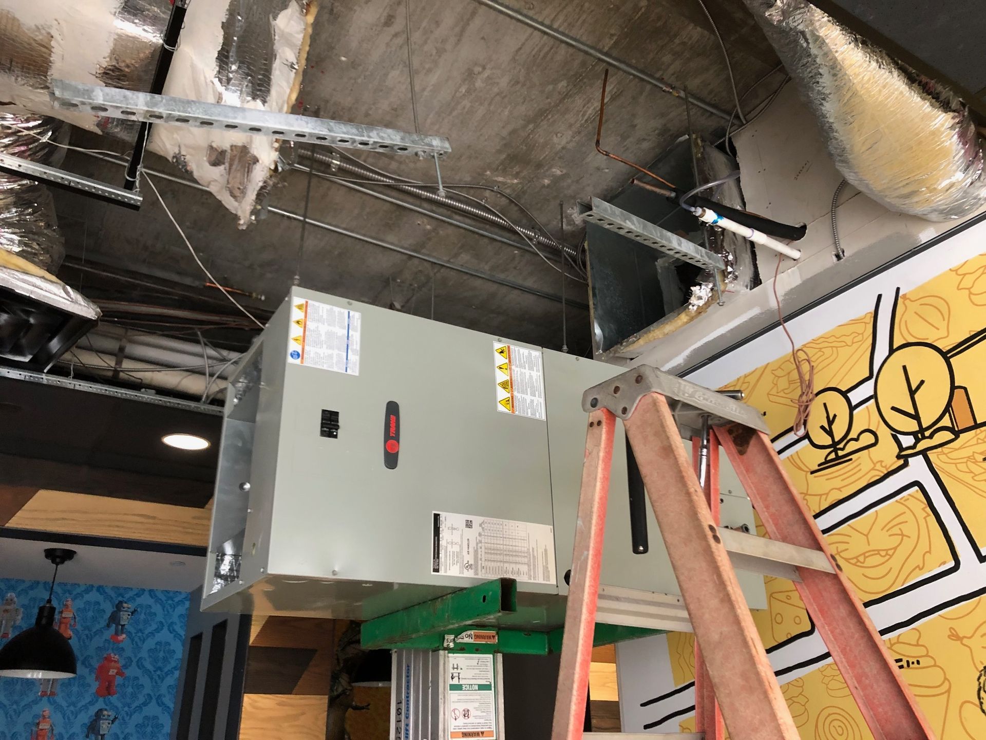 a ladder is sitting next to a box in a room