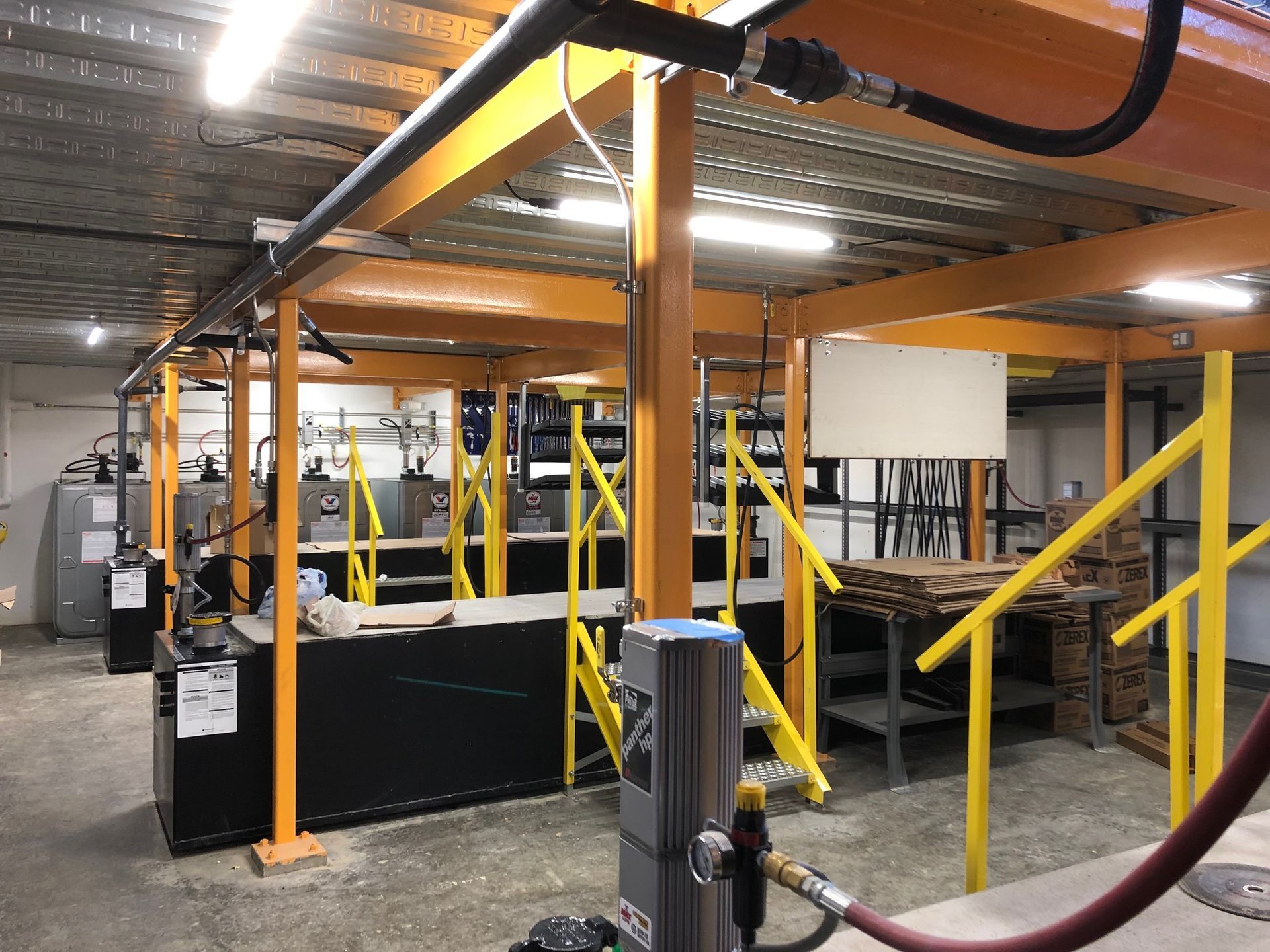 a large room with a lot of pipes and stairs