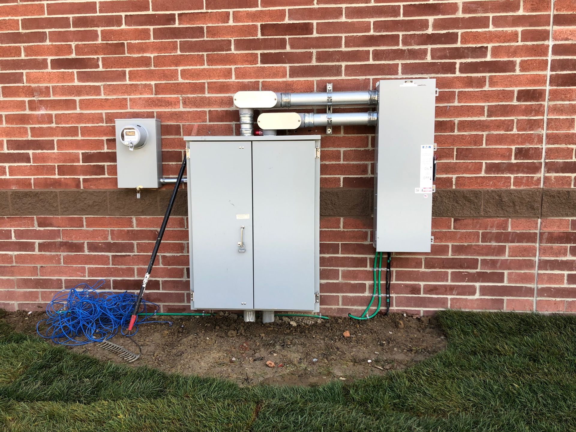 a brick wall with a electrical box attached to it