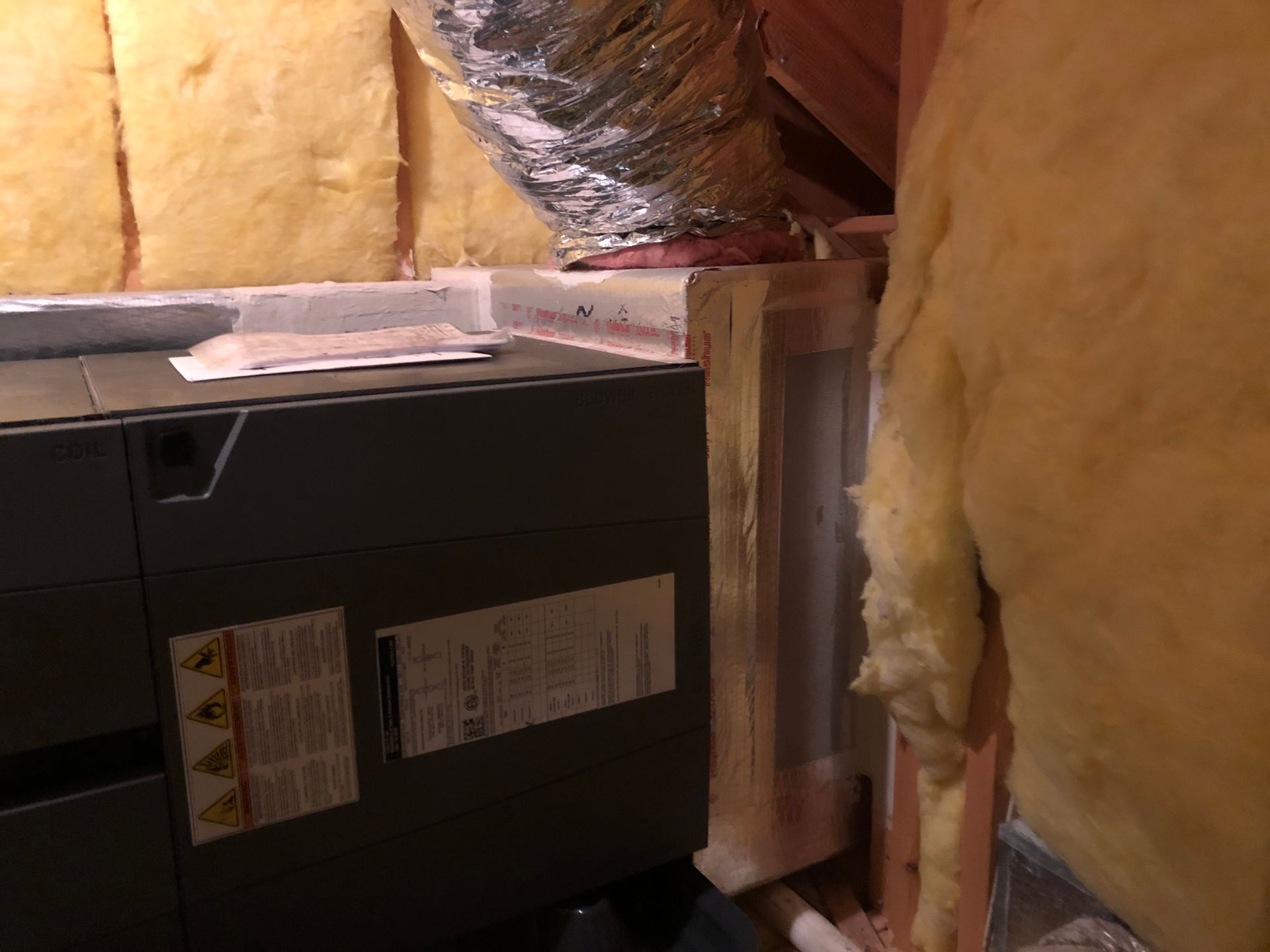 a room with a furnace and a duct coming out of it