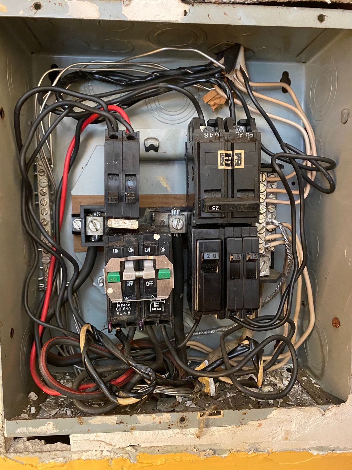 a very messy electrical box with a lot of wires coming out of it