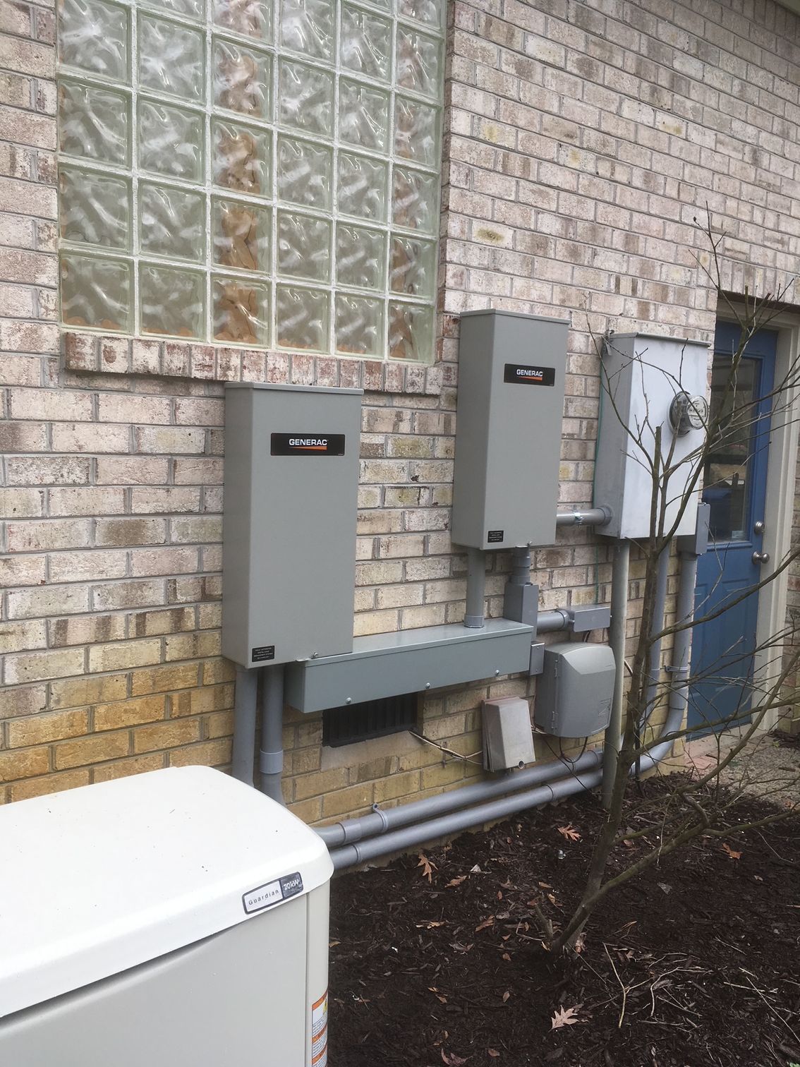 a brick building with electrical boxes on the side of it