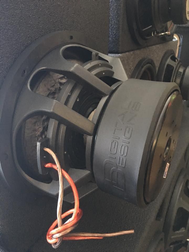 A close up of a subwoofer with a rope coming out of it