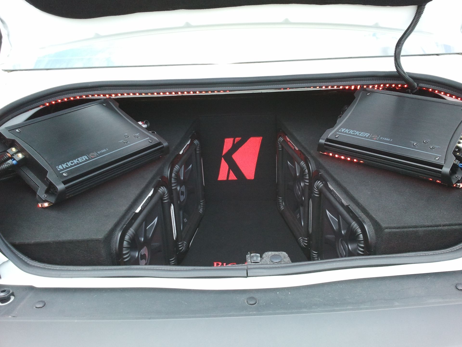 The trunk of a car has a k logo on it