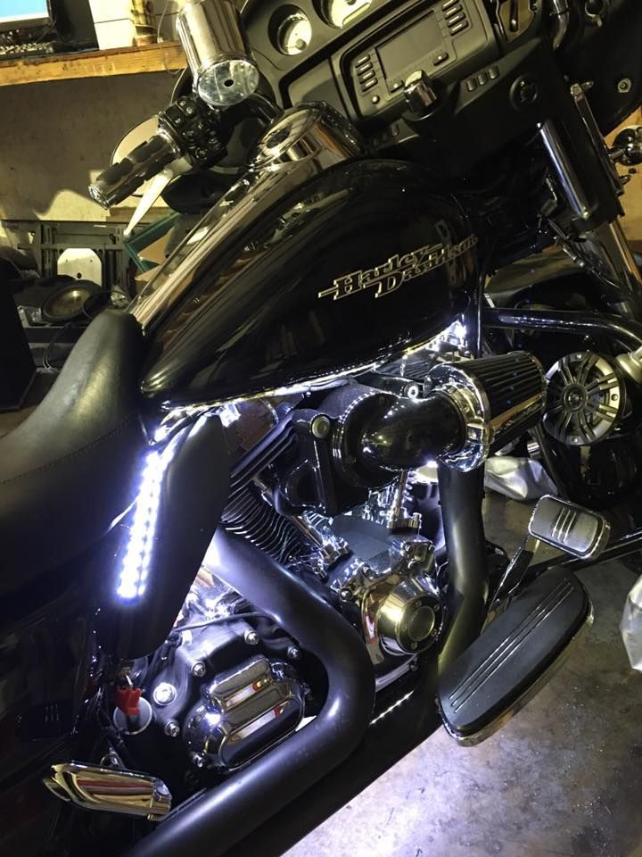 A black harley davidson motorcycle is parked in a garage.