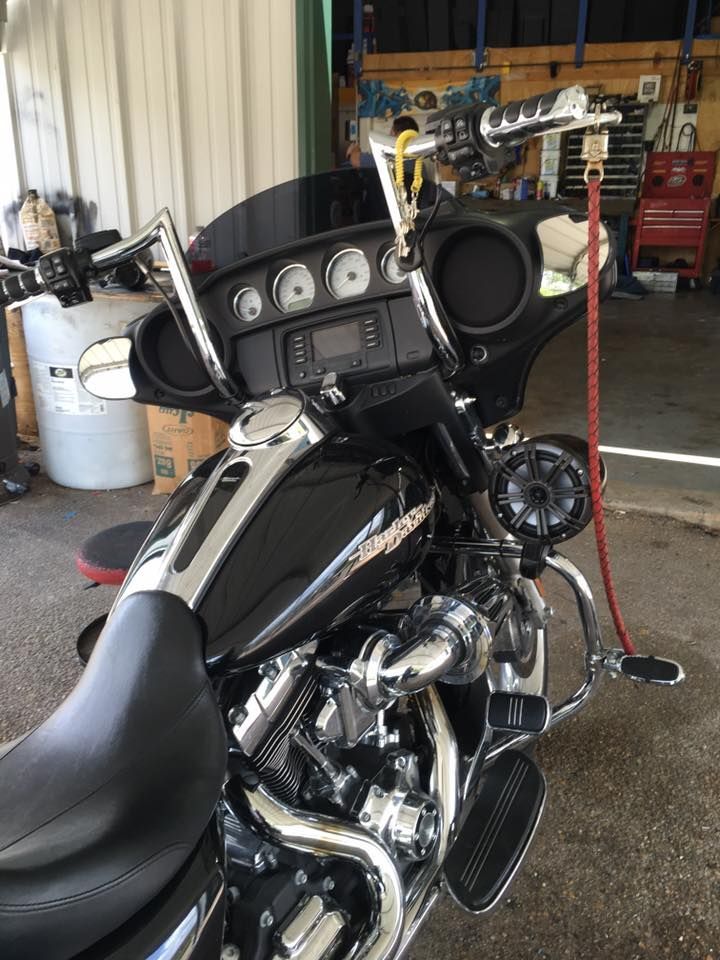 A black harley davidson motorcycle is parked in a garage