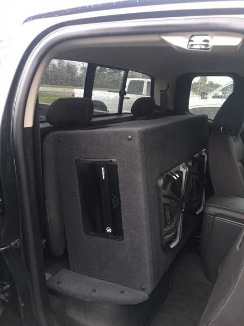 A truck with a subwoofer in the back seat