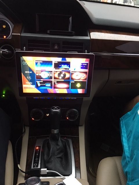 A car dashboard with a tablet on top of it