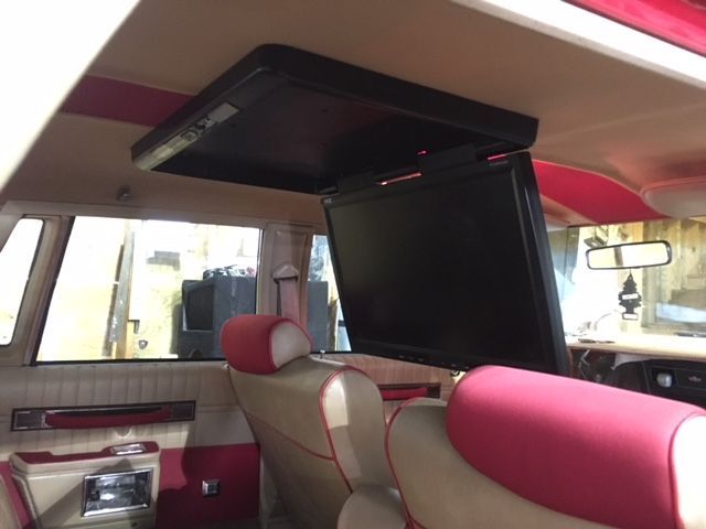 A car with a flat screen tv mounted to the ceiling