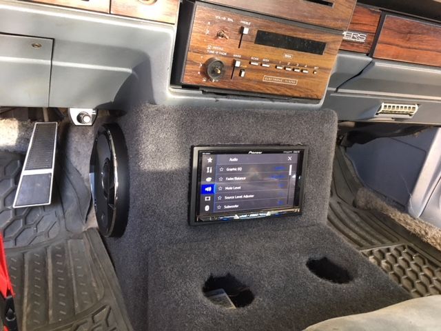 A car dashboard with a radio and a screen