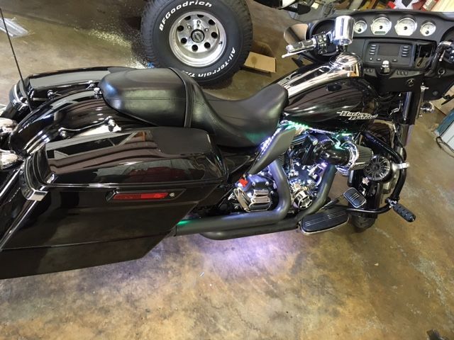 A black harley davidson motorcycle is parked in a garage.