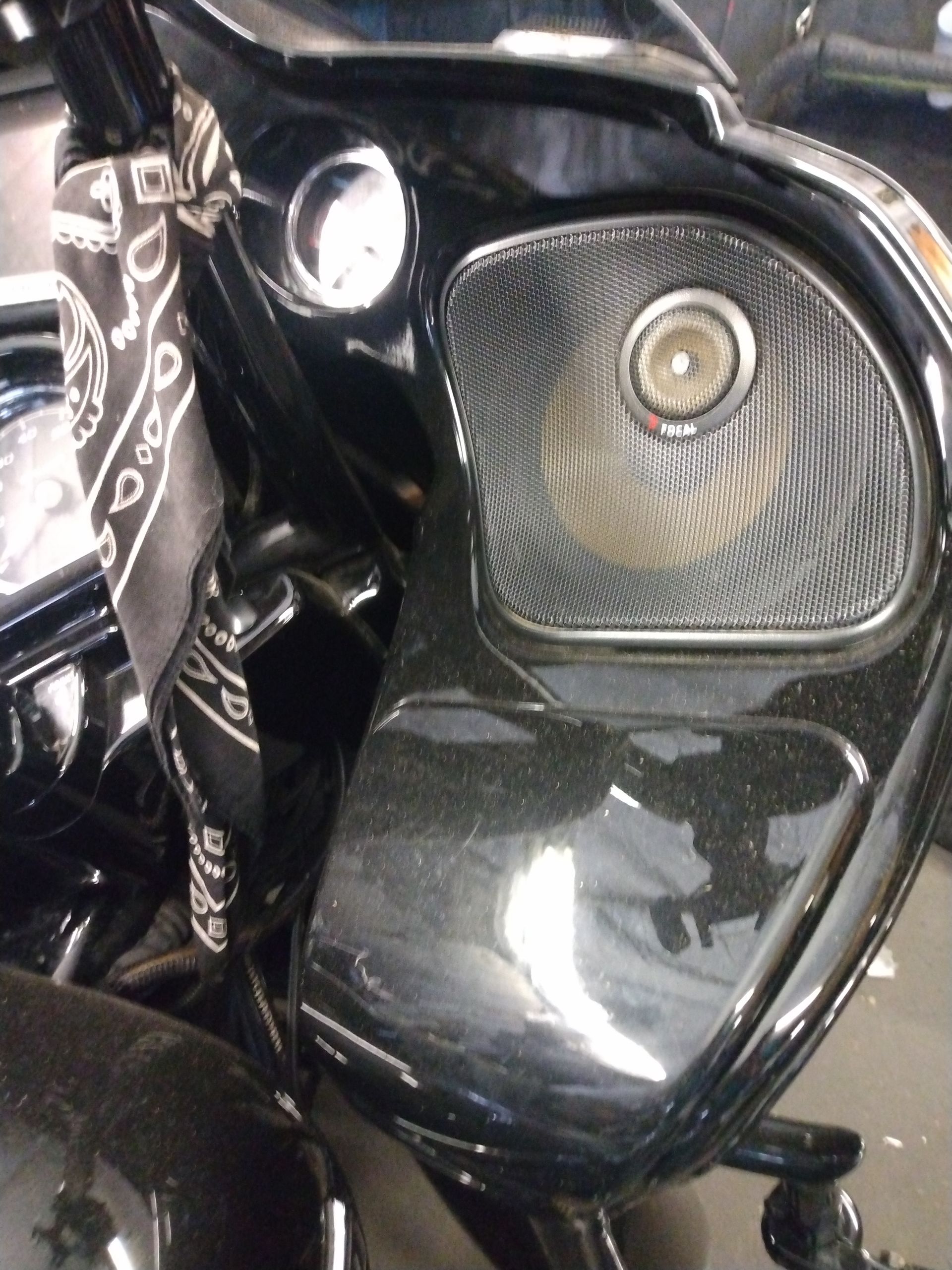 A black motorcycle with a speaker on the side