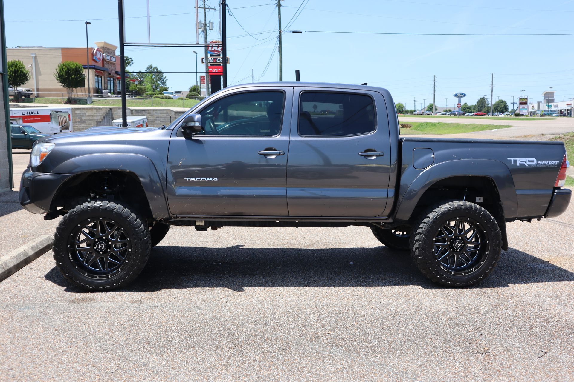 A toyota tacoma truck is parked on the side of the road.