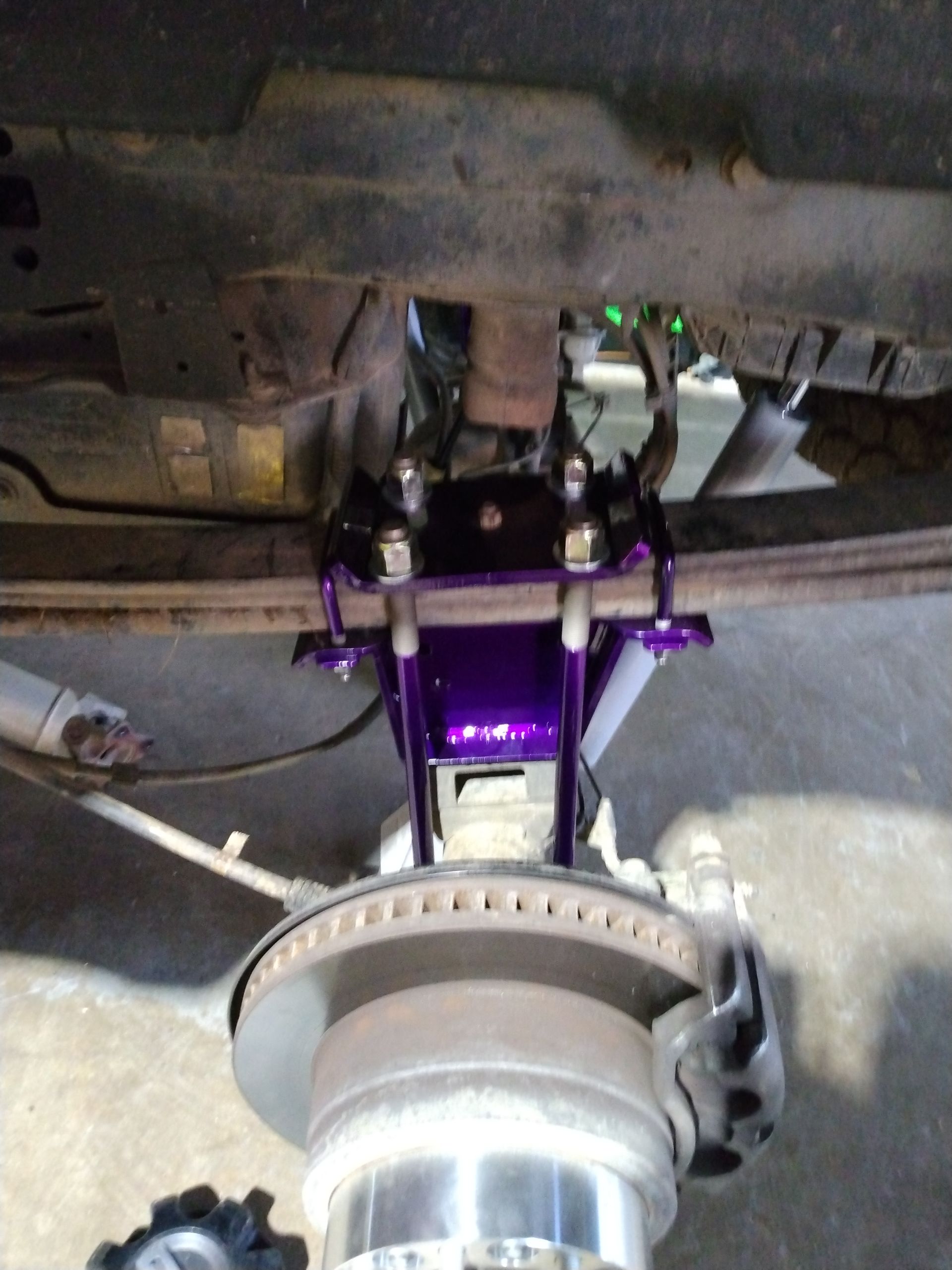 A close up of a purple and silver brake system