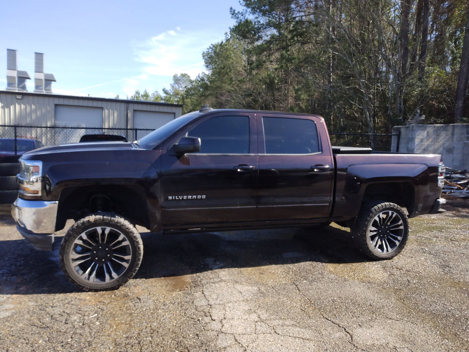 A black pickup truck is parked in a parking lot.