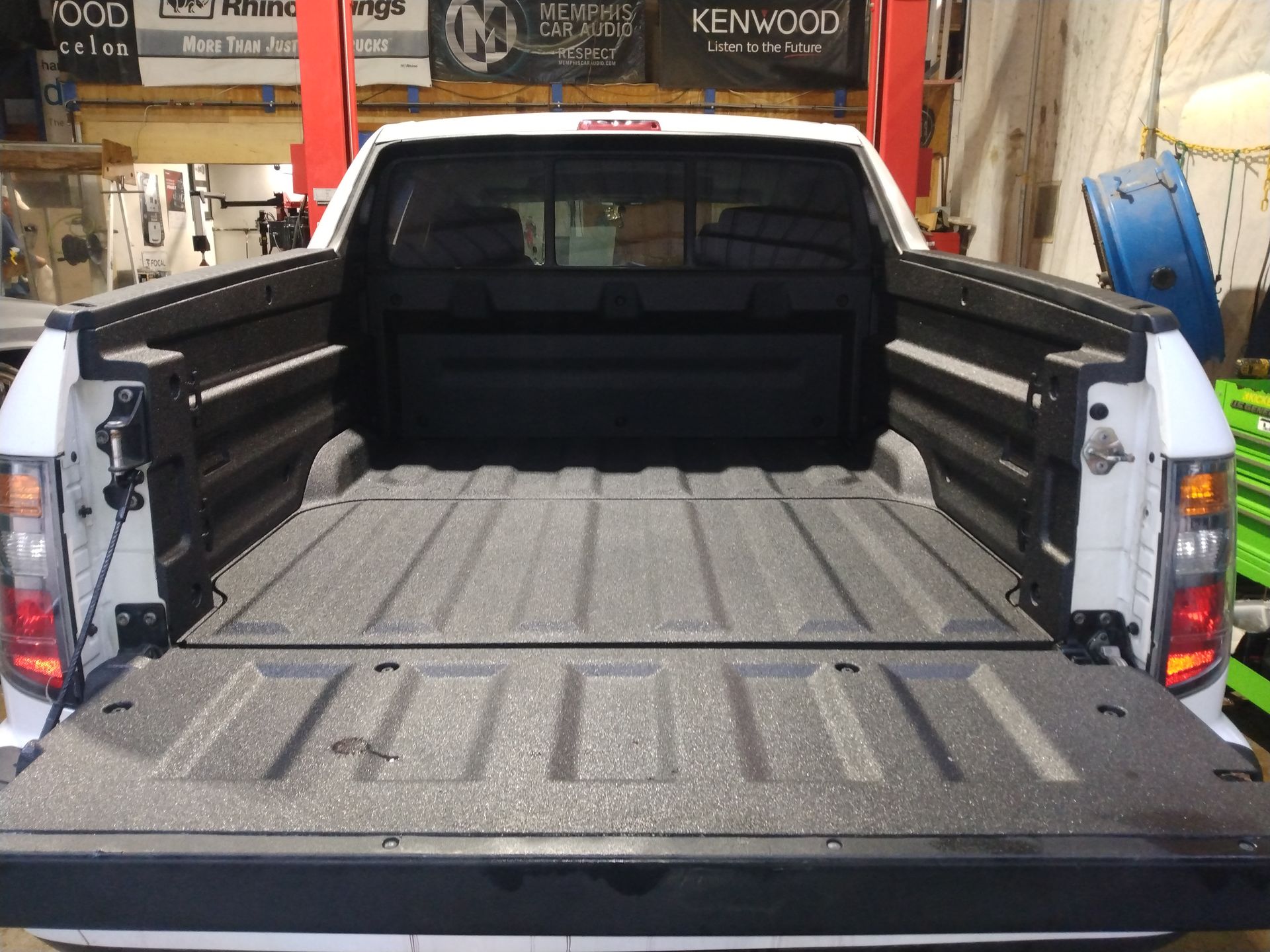 A kenwood truck is parked in a garage