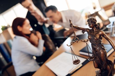 A couple arguing in front of a divorce lawyer.