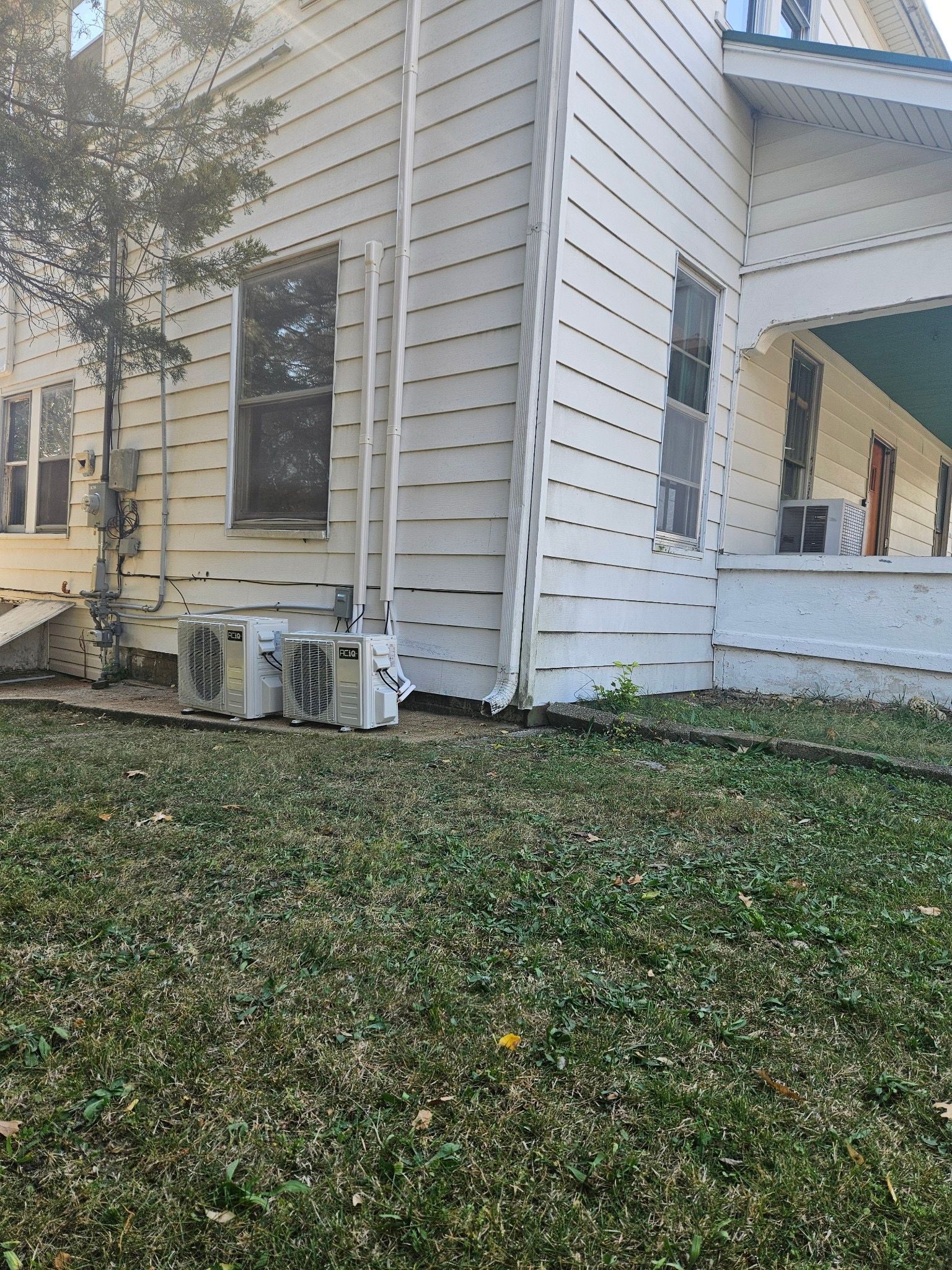 A white house with a ladder on the side of it.