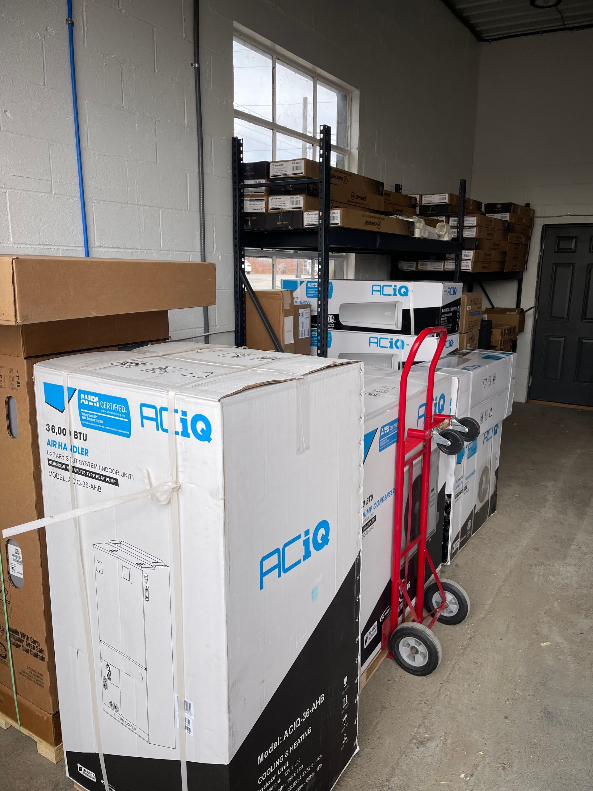 A warehouse filled with boxes and a hand truck.