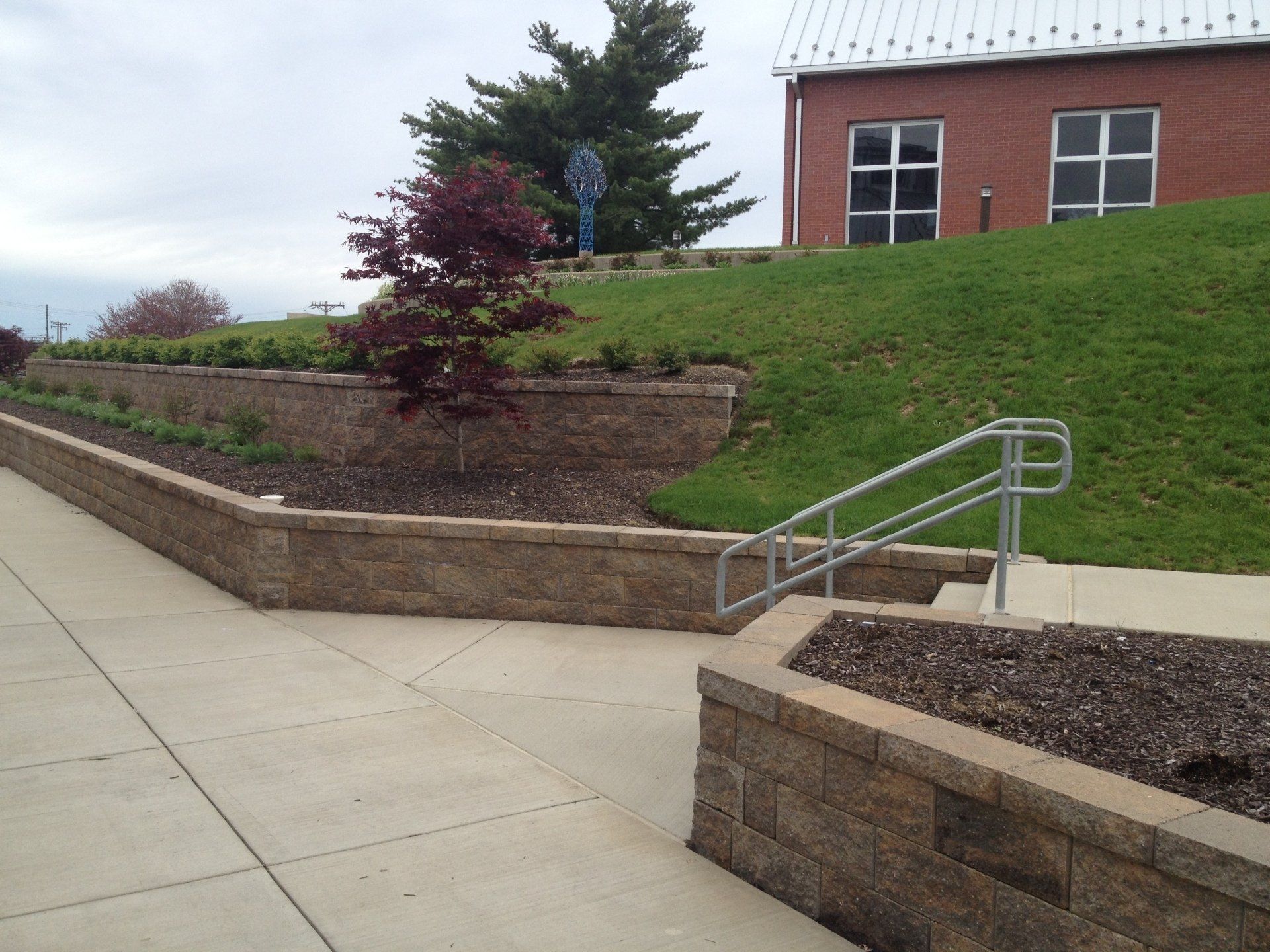 A brick wall with stairs leading up to a building