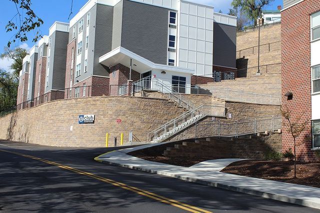 A large apartment building with stairs leading up to it