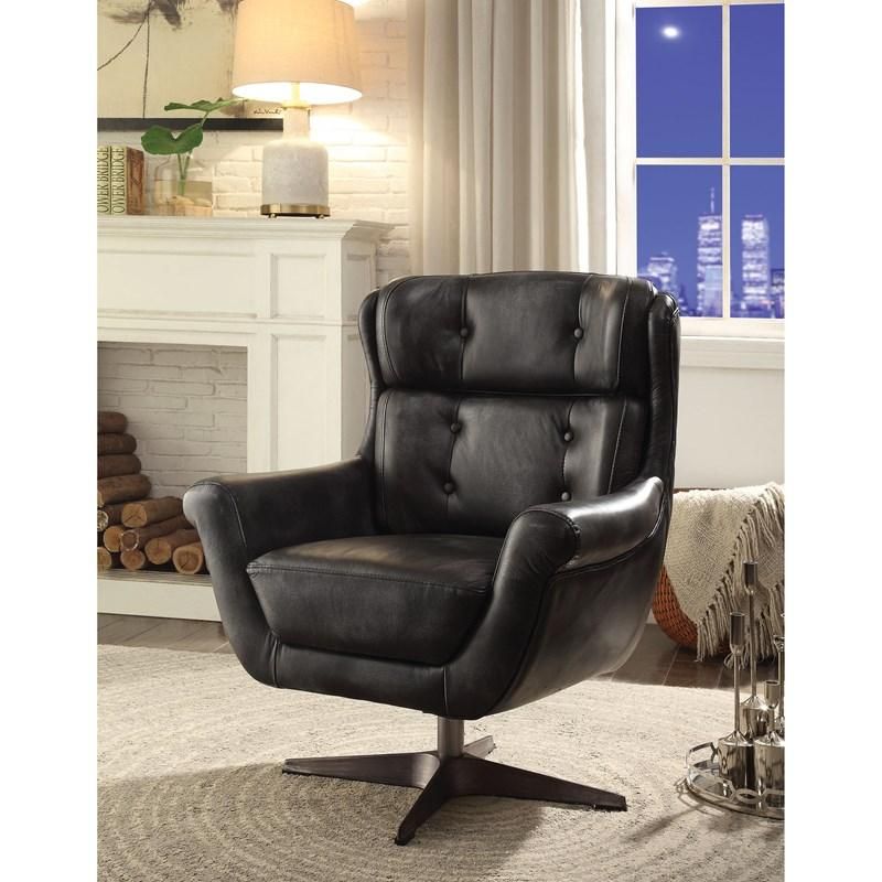 A black leather chair is sitting in a living room next to a fireplace.