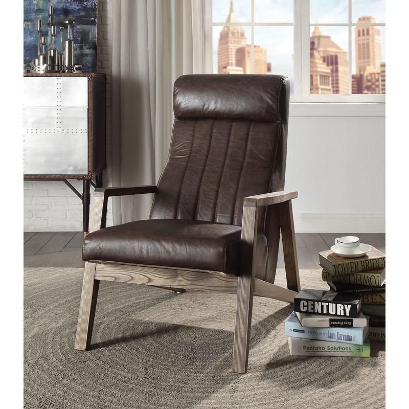 A brown leather chair is sitting next to a stack of century books
