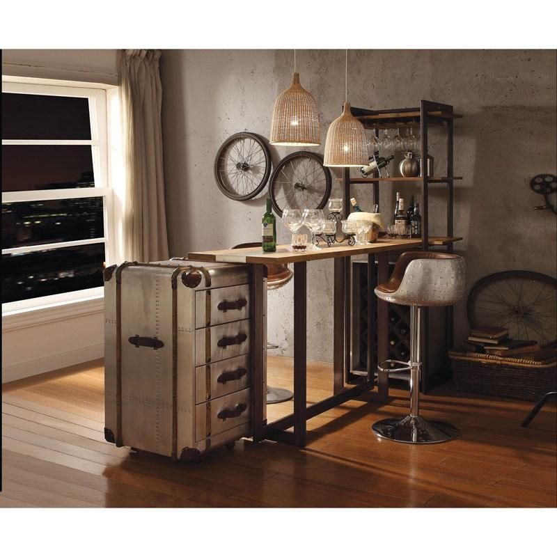 A room with a table and chairs and a suitcase