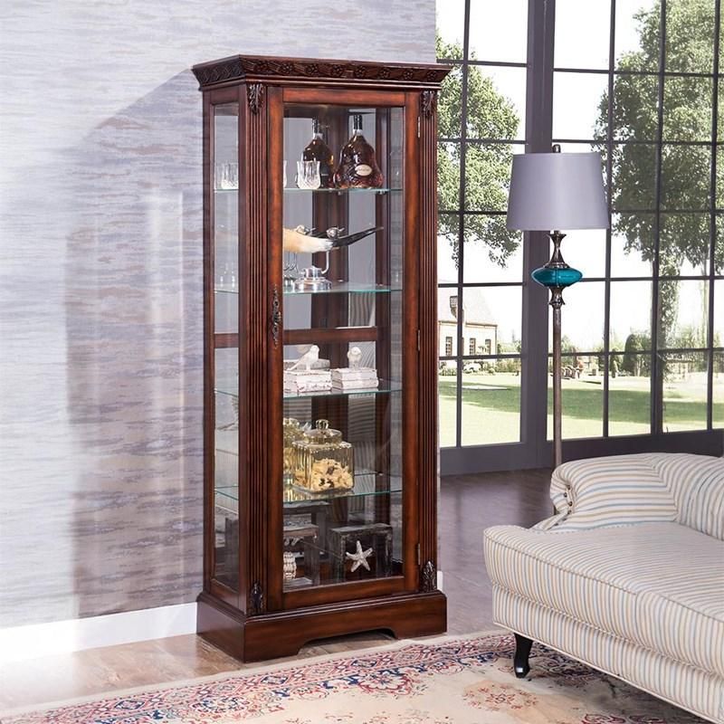 A living room with a couch a lamp and a curio cabinet