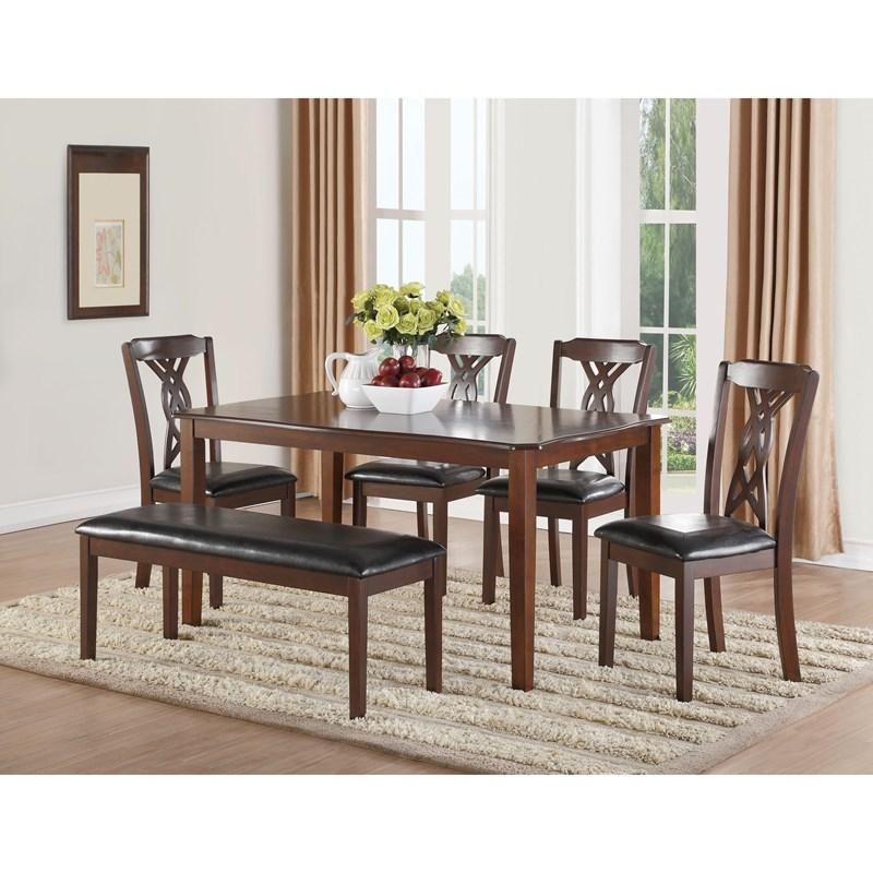 A dining room with a table and chairs and a bench