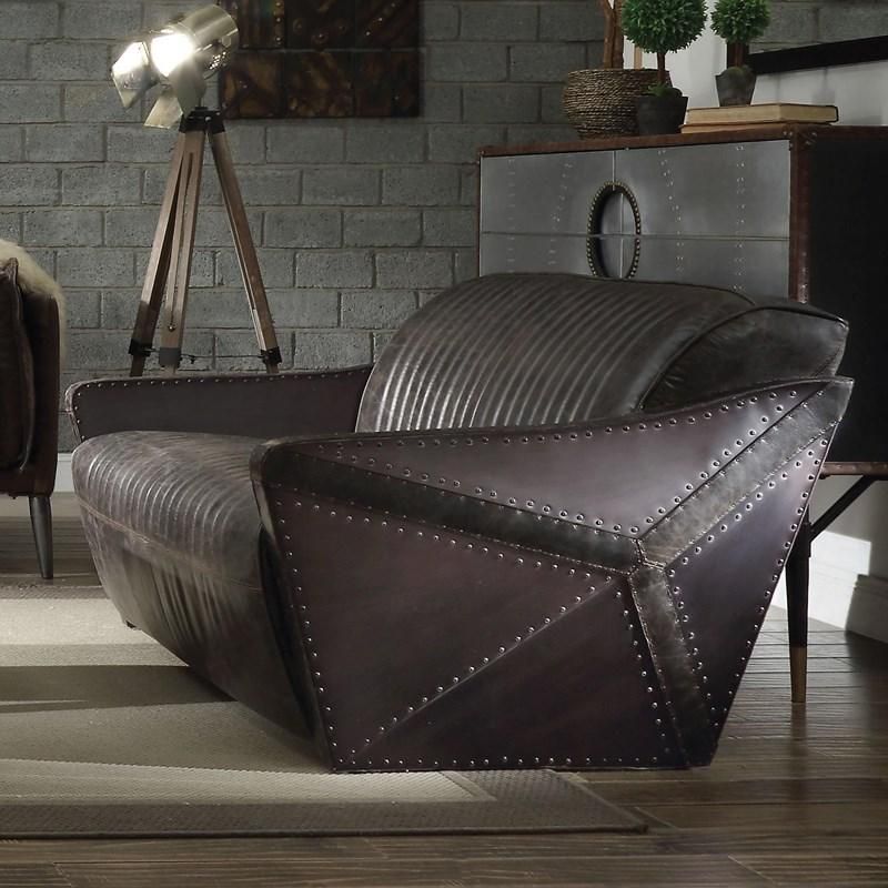 A chair in a living room next to a lamp
