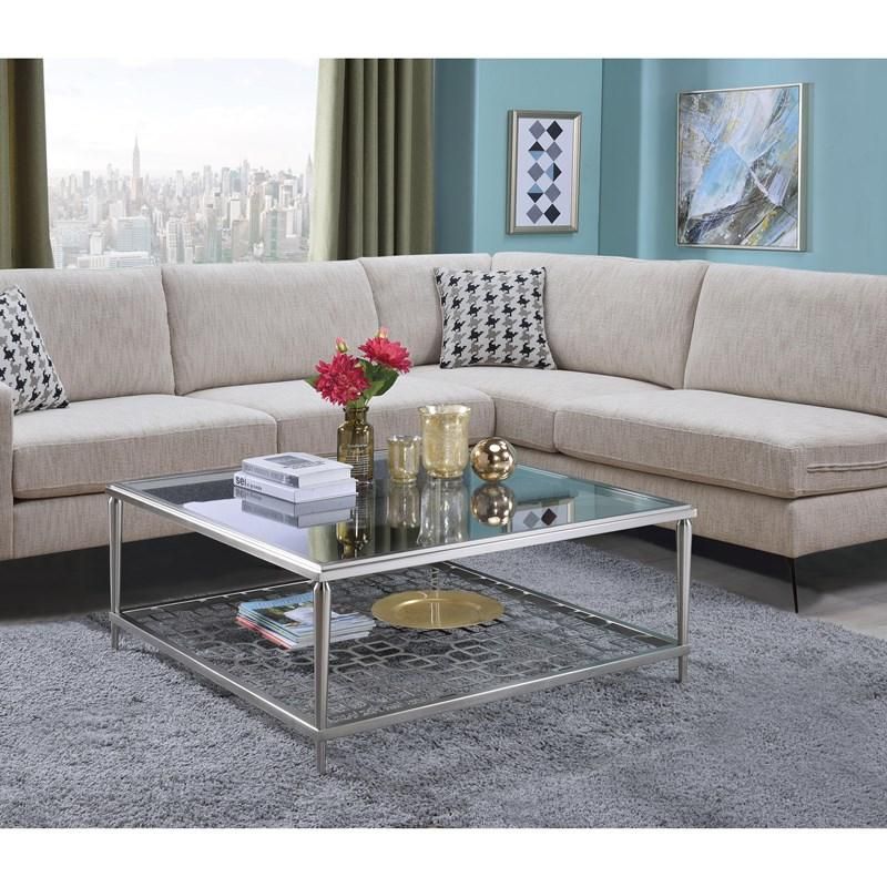 A living room with a sectional couch and a glass coffee table