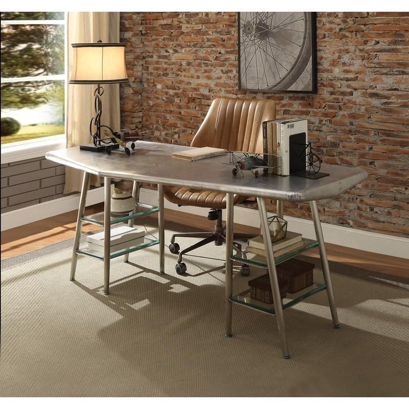 A desk and chair in a room with a brick wall